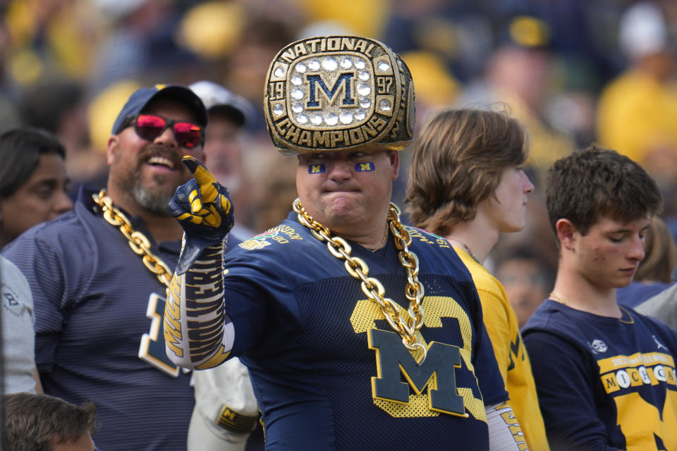 A Michigan fan watches against UNLV in the first half of an NCAA college football game in Ann Arbor, Mich., Saturday, Sept. 9, 2023. (AP Photo/Paul Sancya)