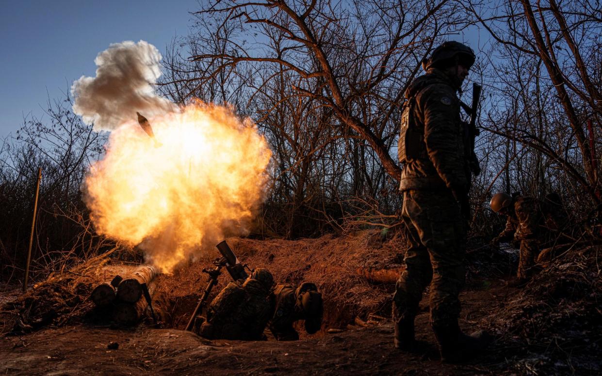 Ukrainian servicemen fire a 120mm mortar towards Russian positions at the frontline near Bakhmut, Donetsk region