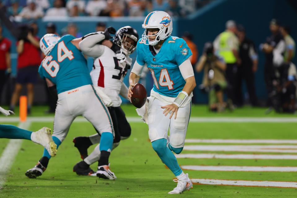 Aug 9, 2024; Miami Gardens, Florida, USA; Miami Dolphins quarterback Mike White (14) runs with the football against the Atlanta Falcons during the fourth quarter at Hard Rock Stadium. Mandatory Credit: Sam Navarro-USA TODAY Sports