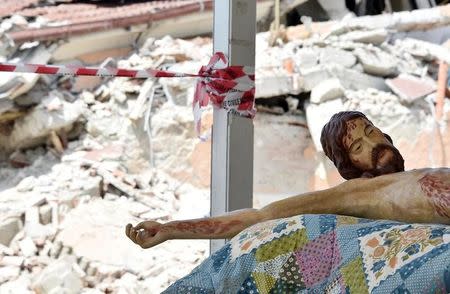A statue of Jesus lies on a table prior to the funeral for victims of the earthquake that leveled the town in Amatrice, central Italy August 30, 2016. REUTERS/Emiliano Grillotti
