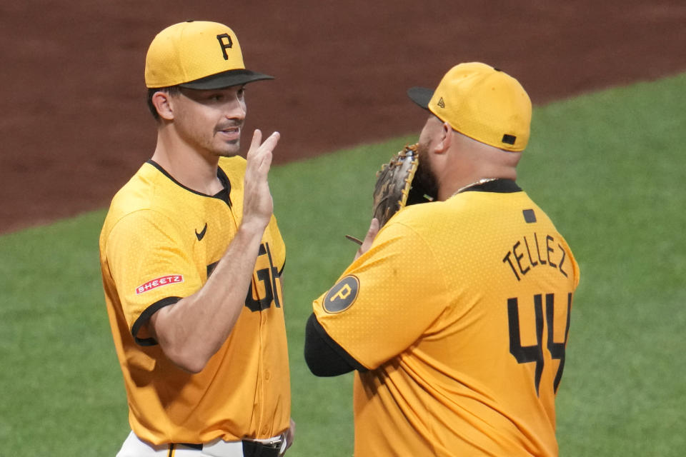 Pittsburgh Pirates' Bryan Reynolds, left, and Rowdy Tellez (44) celebrate after getting the final out of a baseball game against the New York Mets in Pittsburgh, Friday, July 5, 2024. (AP Photo/Gene J. Puskar)