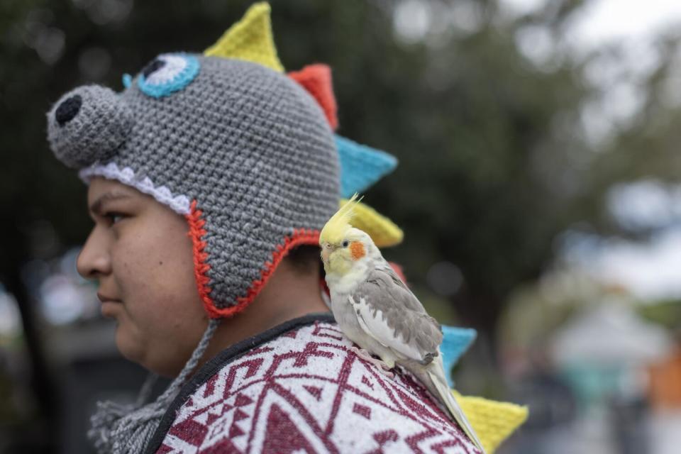 A man with a bird on his shoulder