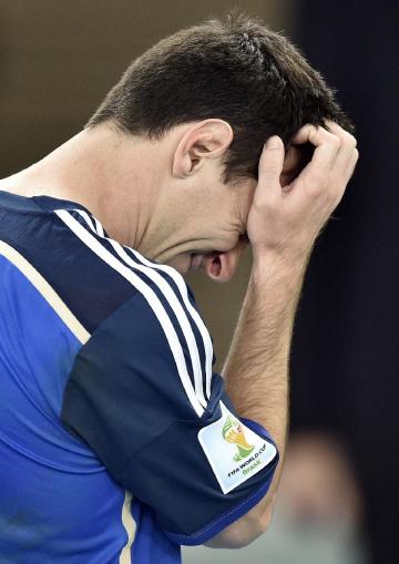 Lionel Messi goes to get his runner-up medal after the World Cup final. (AP)