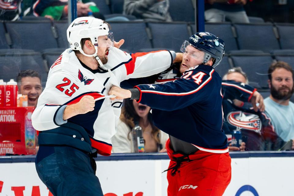 Oct. 5, 2023; Columbus, Ohio, United States;
Columbus Blue Jackets right wing Mathieu Olivier (24) fights with Washington Capitals defenseman Dylan McIlrath (25) during their game on Thursday, Oct. 5, 2023 at Nationwide Arena.