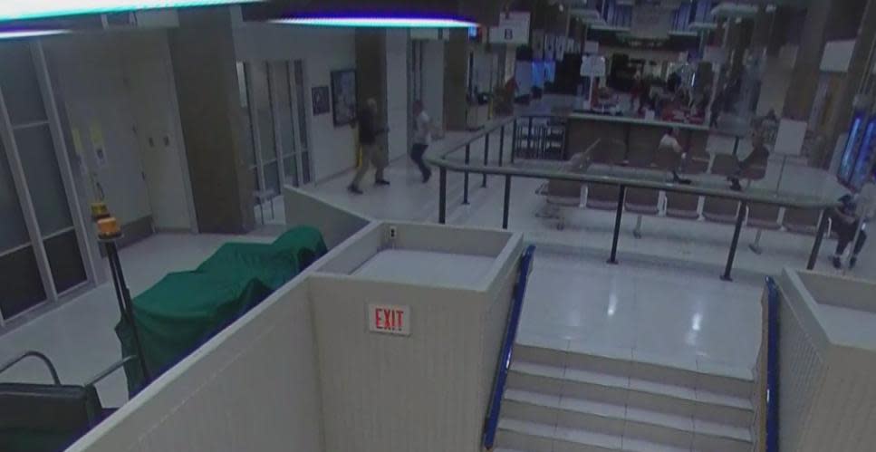 Surveillance footage from Royal University Hospital shows the moments before Kevin Charles Witchekan, standing at centre in white shirt and black pants, stabbed Randy Beauschene, left, with a screwdriver. Witchekan has pleaded guilty to second-degree murder. (Submitted by Court of King's Bench - image credit)