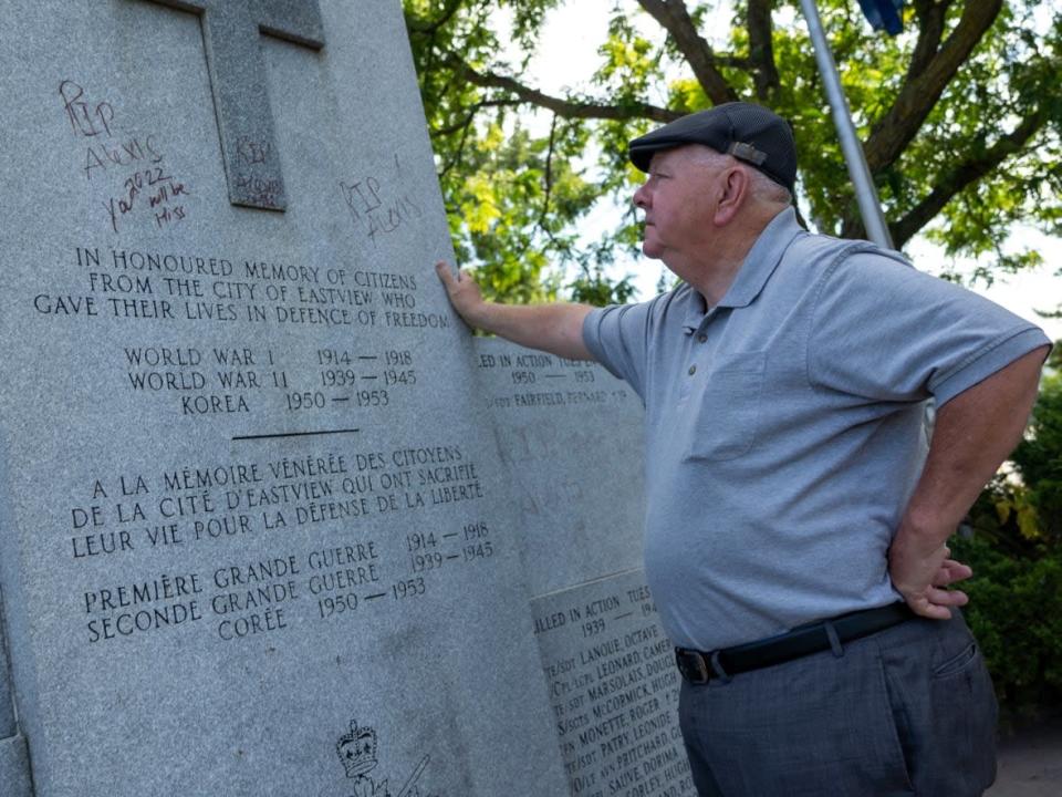 Henry McCambridge, third vice-president of Royal Canadian Legion Branch 462, stares at graffiti on the Eastview City Cenotaph in Vanier on Aug. 5, 2022. He is upset over the vandalism. (Francis Ferland/CBC - image credit)