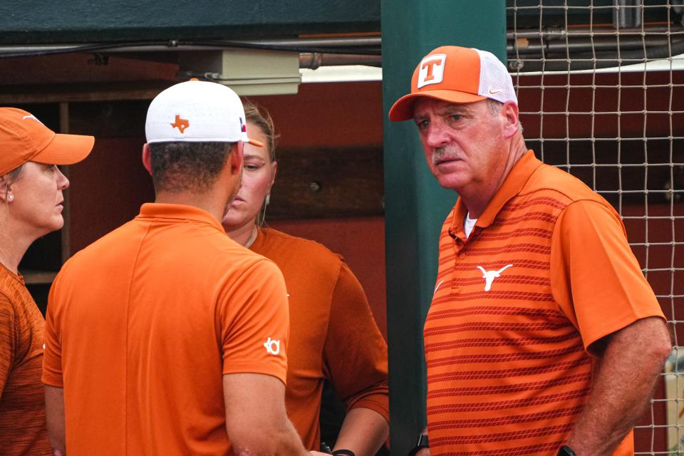 Texas softball coach Mike White, right, saw his team save its season Saturday by rallying from a 5-1 deficit to take a 9-8 extra-inning win over Texas A&M in Game 2 of the best-of-three NCAA Austin Super Regional.