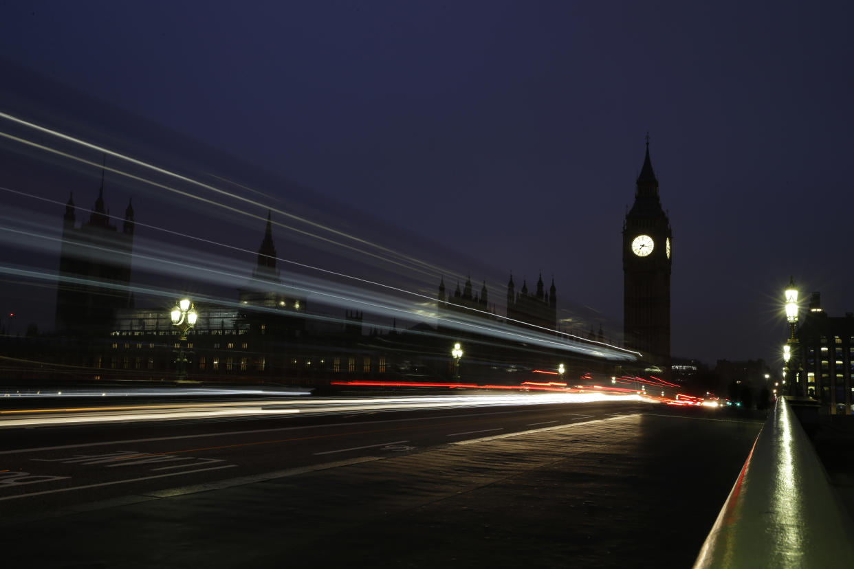 Traffic passes over Westminster Bridge towards the Palace of Westminster with the Elizabeth Tower containing Big Ben, as the daily commute for many workers starts just before sunrise in London, Wednesday, Oct. 26, 2016. (AP Photo/Alastair Grant)