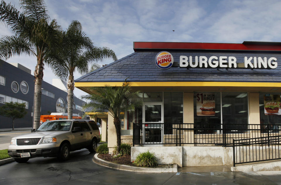 FILE - In this Thursday, April 25, 2013, file photo, a car stops at the drive-thru at a Burger King restaurant near downtown Los Angeles. Restaurant Brands reports financial results Thursday, Aug. 4, 2016. (AP Photo/Nick Ut, File)