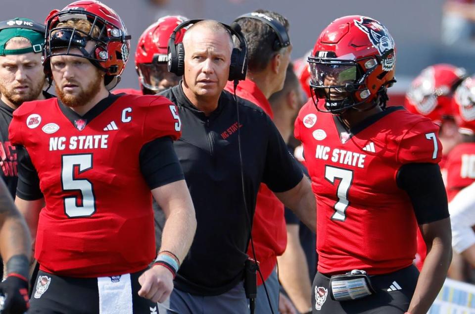 N.C. State head coach Dave Doeren talks with quarterback MJ Morris (7) after he threw an interception during the first half of N.C. State’s game against Marshall at Carter-Finley Stadium in Raleigh, N.C., Saturday, Oct. 7, 2023.