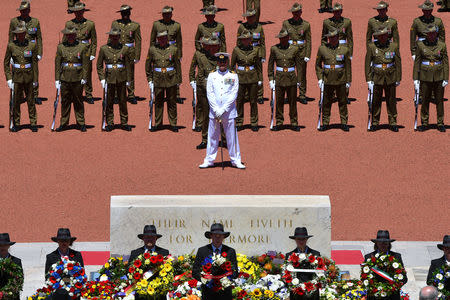Members of Australia's armed forces stand behind officials holding wreaths during a memorial service to mark the centenary of the Armistice ending World War One at the Australian War Memorial in Canberra, Australia, November 11, 2018. AAP/Mick Tsikas/via REUTERS