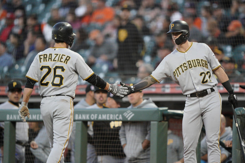 Pittsburgh Pirates' Kevin Newman (27) congratulates Adam Frazier (26) after he scored on a single by Kevin Kramer against the San Francisco Giants during the second inning of a baseball game Wednesday, Sept. 11, 2019, in San Francisco. (AP Photo/Tony Avelar)