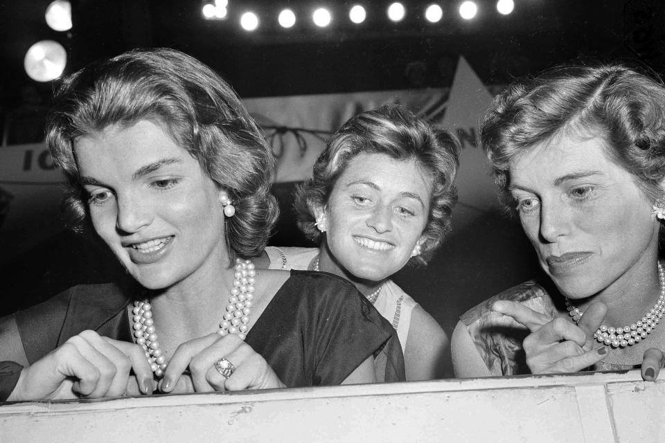 FILE - In this Aug. 14, 1956, file photo, from left: Jacqueline Kennedy, wife of Sen. John F. Kennedy (D-Mass.); Jean Kennedy Smith, the senator's sister; and Eunice Kennedy Shriver look on during the second day of the Democratic National Convention in Chicago. The death on Wednesday, June 17, 2020, of Jean Kennedy Smith, the last surviving sibling of President Kennedy, means Camelot's inner circle is almost gone. (AP Photo, File)