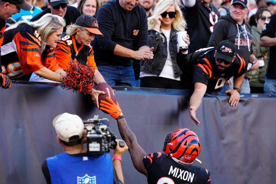 Cincinnati Bengals running back Joe Mixon (28) hands a touchdown ball to a fan in the second quarter during a Week 9 NFL game, Sunday, Nov. 6, 2022, at Paycor Stadium in Cincinnati. Mandatory Credit: Sam Greene-The Enquirer