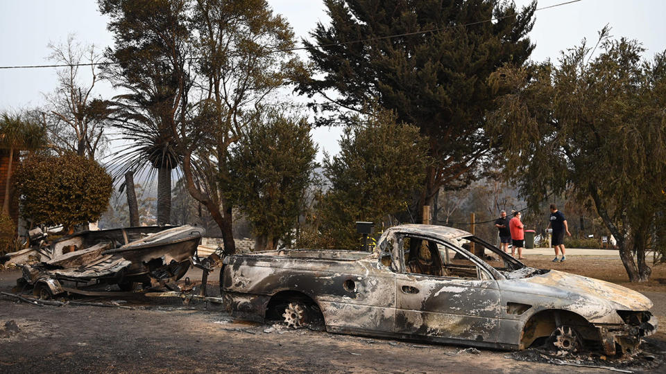 Vehicles gutted by bushfires, pictured here in the town of Lake Conjola.
