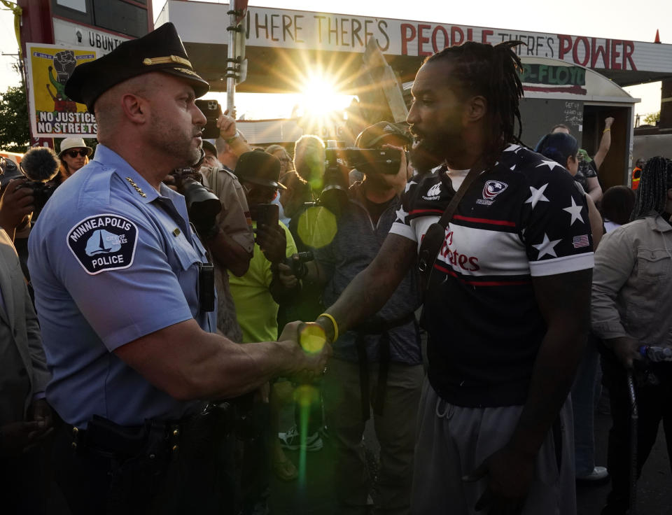 Minneapolis Police Chief Brian O'Hara, left, shakes hands with an activist on the three-year anniversary of George Floyd's death at George Floyd Square, Thursday, May 25, 2023, in Minneapolis. The murder of Floyd at the hands of Minneapolis police, and the fervent protests that erupted around the world in response, looked to many observers like the catalyst needed for a nationwide reckoning on racism in policing. (AP Photo/Abbie Parr)