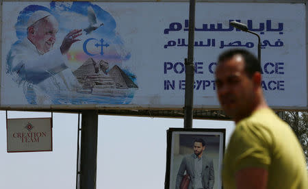 A man looks on near a billboard ahead of Pope Francis’ visit in Cairo, Egypt April 26, 2017. REUTERS/Amr Abdallah Dalsh