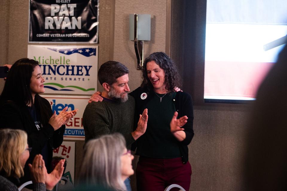 Jen Metzger high-fives her husband after talking about win for the Ulster County executive position at the election night watch party in Kingston, NY on Tuesday, November 8, 2022.