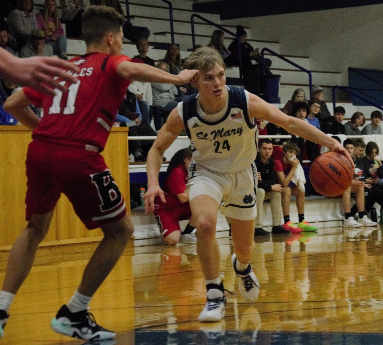 Brody Jeffers looks to drive during a boys basketball matchup between Gaylord St. Mary's and Bellaire on Tuesday, February 7/