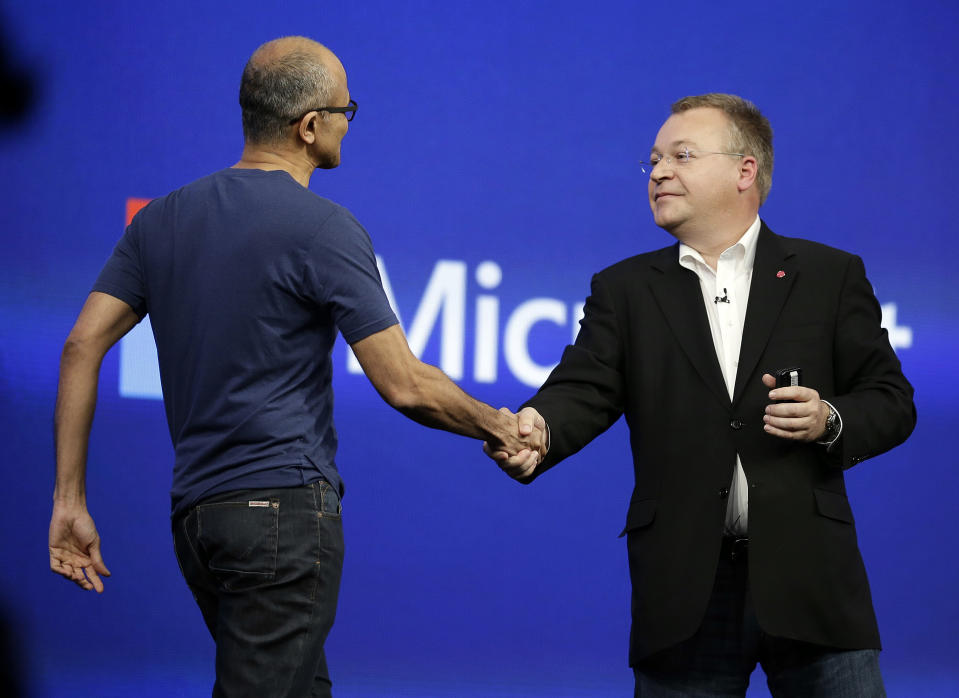 Microsoft CEO Satya Nadella, left, is greeted by Stephen Elop, right, executive vice president of Nokia, during the keynote address of the Build Conference Wednesday, April 2, 2014, in San Francisco. Microsoft kicked off its annual conference for software developers, with new updates to the Windows 8 operating system and upcoming features for Windows Phone and Xbox. (AP Photo/Eric Risberg)