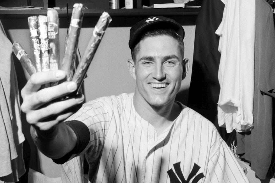 FILE - New York Yankees Fritz Peterson, whose wife gave birth to a boy earlier in the day, holds cigars in the locker room at Yankee Stadium , Aug. 2, 1967, in New York. Peterson, the New York Yankees pitcher who created a controversy when he swapped wives and families with teammate Mike Kekich in 1973, died of lung cancer at his home in Winona, Minn., on Oct. 19, according to the death certificate filed with the Winona County Vital Records Department. He was 81. (AP Photo/File)