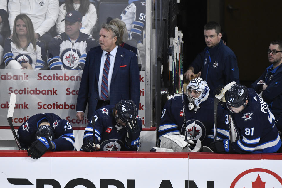 Winnipeg Jets' head coach Rick Bowness, left center, and players react at the end of Game 5 of an NHL hockey Stanley Cup first-round playoff series against the Colorado Avalanche in Winnipeg, Manitoba, Tuesday April 30, 2024. (Fred Greenslade/The Canadian Press via AP)