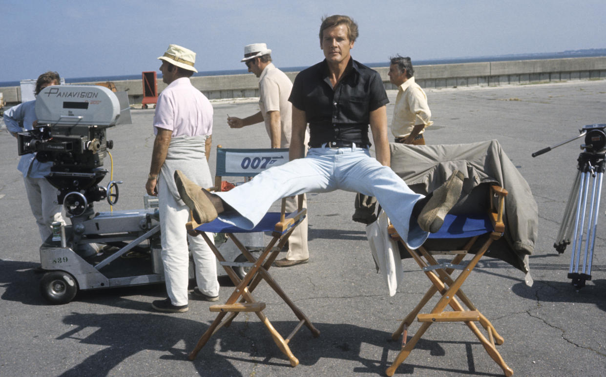 KINGSTON, JAMAICA - MARCH 1: Roger Moore relaxes on location for the filming of James Bond film 'Live And Let Die' on March 1, 1973 in Kingston, Jamaica (Photo by Anwar Hussein/Getty Images)