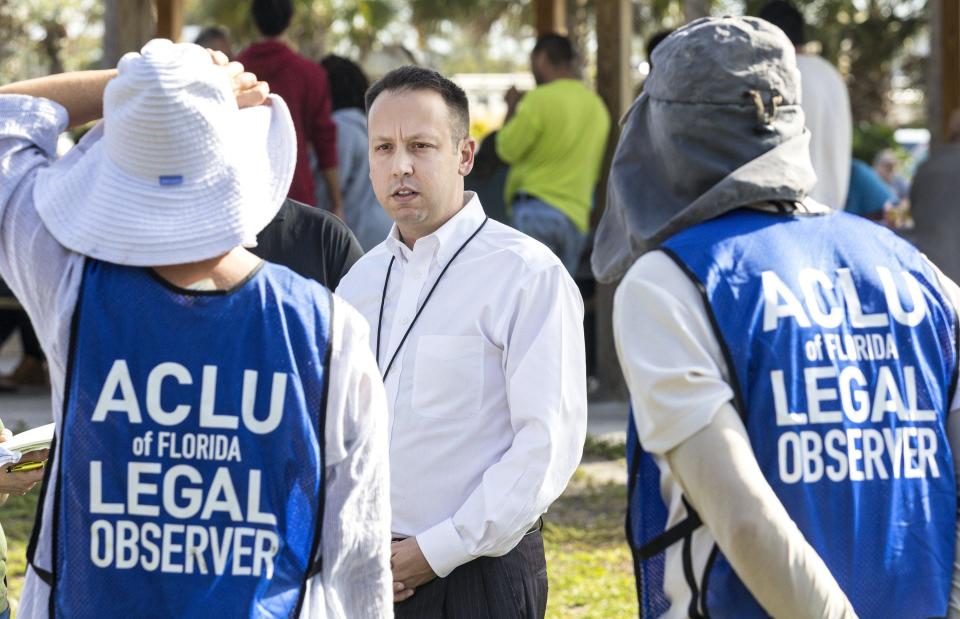 Palm Beach County Mayor Dave Kerner talks Wednesday with ACLU volunteer legal observers while county workers interview homeless people at Tent City in John Prince Park. [LANNIS WATERS/palmbeachpost.com]