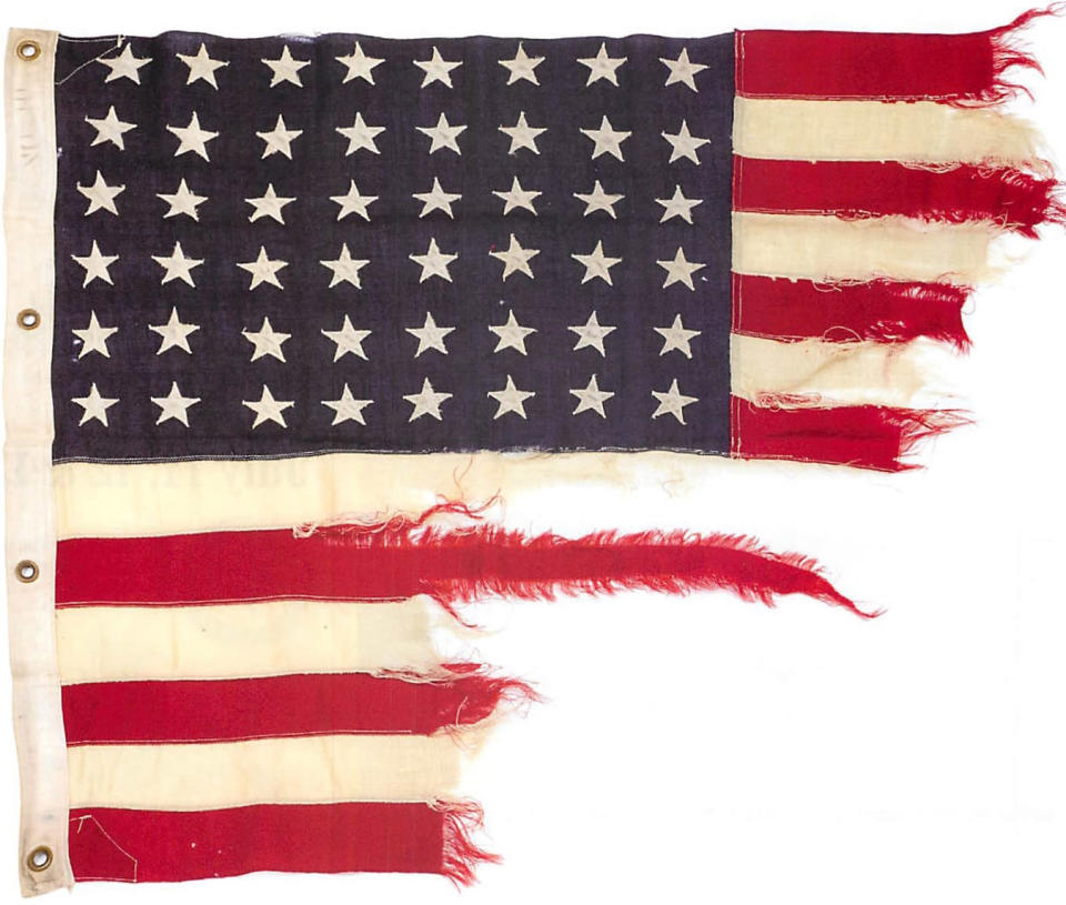 <p> This photo provided by collector Rodney Hilton Brown shows a tattered 48-star American flag that flew aboard the U.S.-built LST 493 on D-Day that is being auctioned by Bonhams in New York on Thursday, June 5, 2014. The flag is among the hundreds of D-Day and other World War II artifacts being auctioned a day before the 70th anniversary of the history-changing invasion. The auction also features rare print-outs of the original series of hourly Dow Jones news bulletins with some of the first reports of the fighting on France’s north coast on June 6, 1944. (AP Photo/Courtesy of Rodney Hilton Brown) </p>