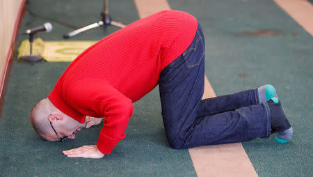 A man cries while he prays at the Quebec Islamic Cultural Centre in Quebec City, February 1, 2017. REUTERS/Mathieu Belanger