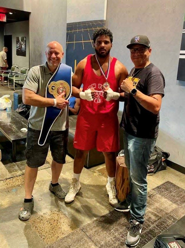 Wappingers Falls boxer Miguel Matias, center, is flanked by his trainer Derrick Ohlhoff and friend Kevin Escobar as he readies for a fight on Nov. 4, 2023 in the New York Metro Championships.