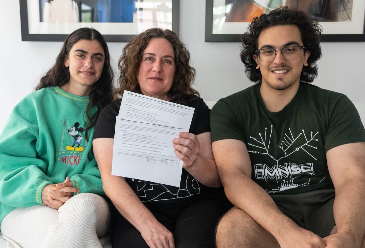 Priyanka Kashyap, left, with her mother Caroline Novak and brother Ashwin Kashyap. The family was shocked and frustrated when they were issued parking tickets associated with a licence plate they had reported stolen. (Laura Pedersen/CBC - image credit)