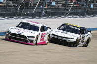 Austin Cindric, left, competes with AJ Allmendinger, right, during a NASCAR Xfinity Series auto race at Dover International Speedway, Tuesday, June 15, 2021, in Dover, Del. Cindric won the race. (AP Photo/Chris Szagola)