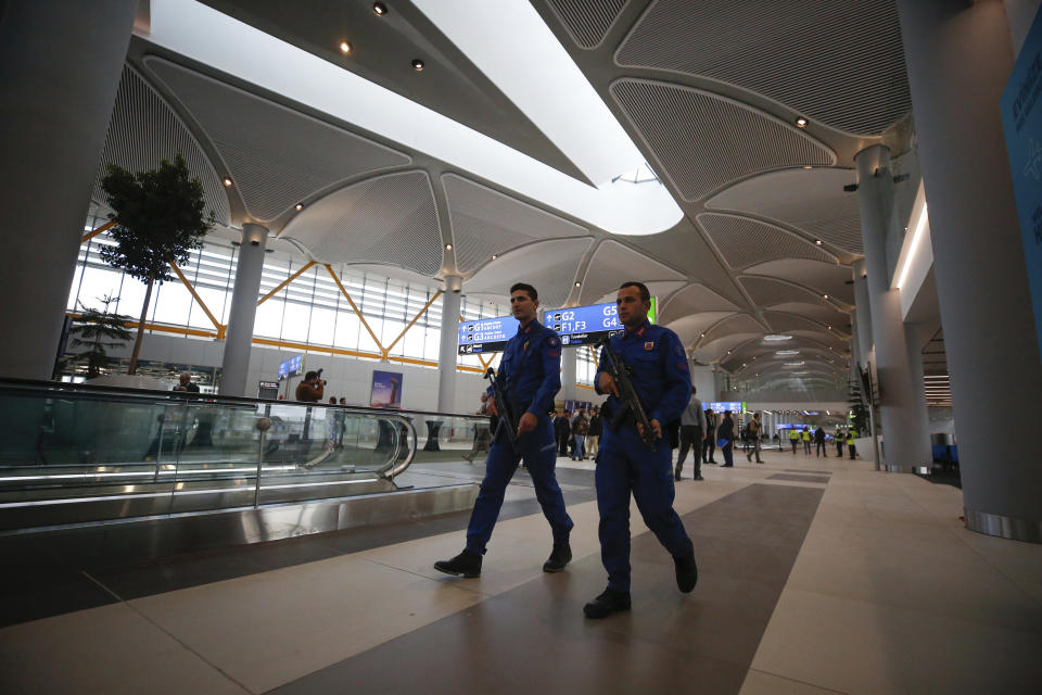 FILE - In this Oct. 25, 2018, file photo, Turkish police patrol a terminal at Istanbul's new airport, ahead of its opening. The first phase of the airport, one of Turkey's President Recep Tayyip Erdogan's major construction projects, is scheduled to be inaugurated on Oct. 29 when Turkey celebrates Republic Day. The massive project, has been mired in controversy over worker's rights and environmental concerns amid a weakening economy. (AP Photo/Emrah Gurel, File)