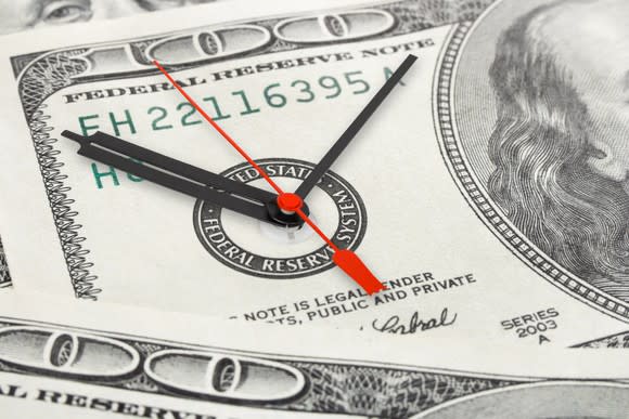 CLock inside hundred dollar bill