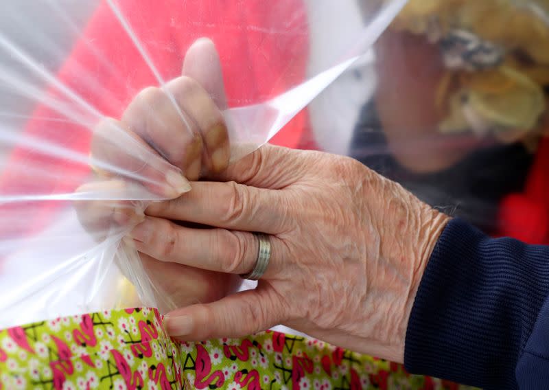 Residents at Belgian nursing home "Le Jardin de Picardie" enjoy hugs and cuddle through a wall made with plastic sheets to protect against potential COVID-19 infection in Peruwelz