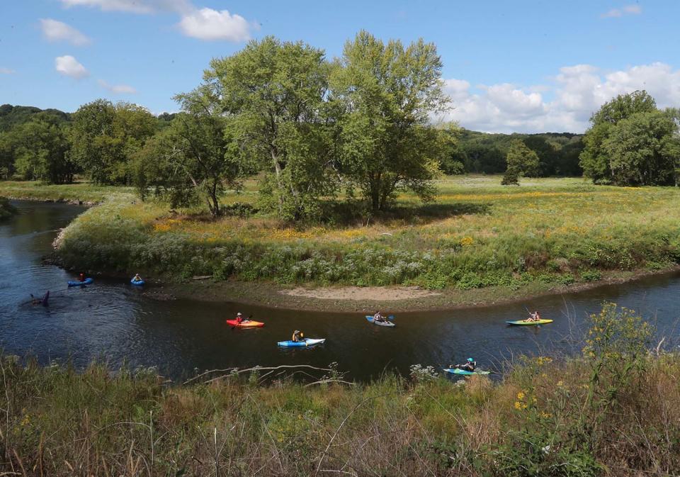 Kayakers make their way along the Cuyahoga River during the Valley View River Celebration  at Akron's Cascade Valley Metro Park.