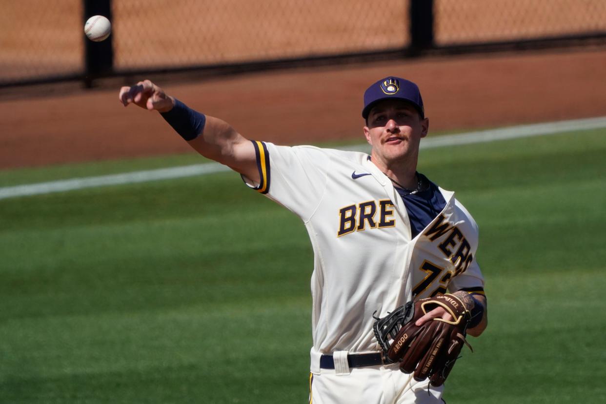 Shortstop Brice Turang makes the throw for an out against the Los Angeles Angels during a spring training game.