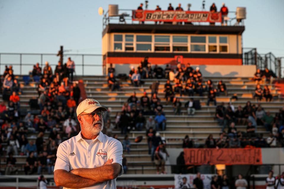 Refugio head coach Jason Herring watches the team warm up before the game on Friday, Oct. 21, 2022, at Bobcat Stadium in Refugio, Texas.