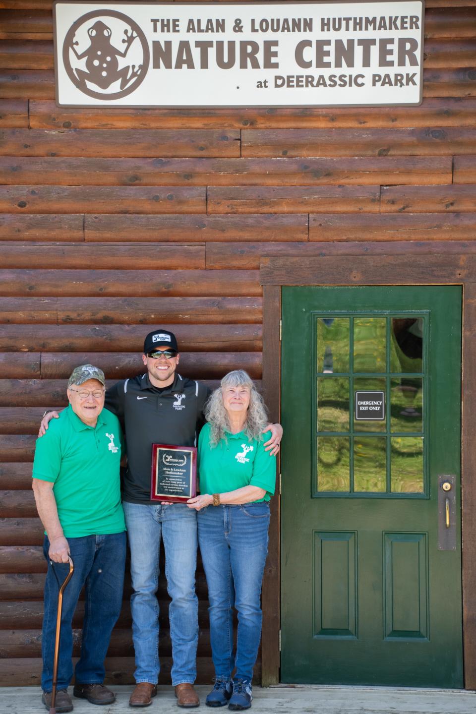 Alan Huthmaker, Luke Fabian and LouAnn Huthmaker in front of the newly named Alan and LouAnn Huthmaker Nature Center.