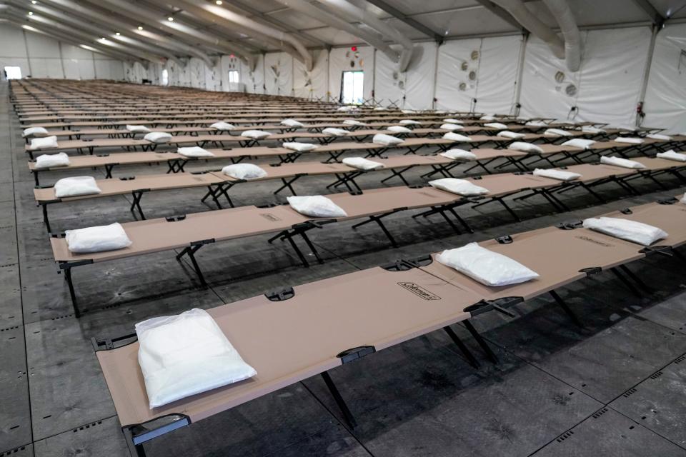 Bags containing a pillow, towel, and bed sheets are placed on cots inside a dormitory tent at the Creedmoor Psychiatric Hospital shelter New York City set up to house up to 1,000 migrants in the Queens borough of New York, Tuesday, Aug. 15, 2023.