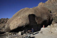 Benito Hernandez stands outside his home near San Jose de Las Piedras in Mexico's northern state of Coahuila January 16, 2013. For over 30 years, Hernandez, his wife Santa Martha de la Cruz Villarreal and their family have lived in an odd sun-dried brick home with a huge 40 metre (131 feet) diameter rock used as a roof. The dwelling is found close to the town of San Jose de Piedras, a remote community located in the arid desert of Coahuila, some 80 km (49 miles) from the border with Texas. Picture taken January 16, 2013. REUTERS/Daniel Becerril (MEXICO - Tags: SOCIETY TPX IMAGES OF THE DAY) - RTR3CRUP