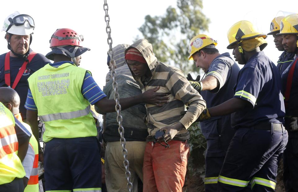 A suspected illegal miner is led away after being rescued from an abandoned gold shaft in Benoni