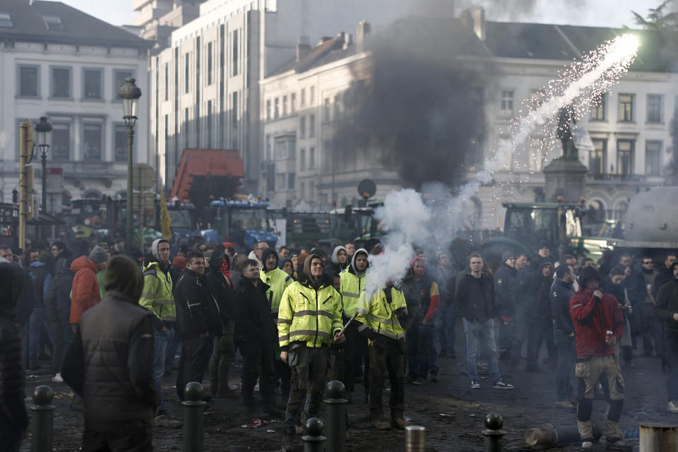 Demonstrator confront police during a farmers protest calling for higher incomes and protection from foreign competition, at Place du Luxembourg near the European Parliament building in Brussels on February 1, 2024. European farmers took their growing protest over low prices and the threat of competition from South American agri-food importers to Brussels on February 1, 2024, clogging the streets with 1,300 tractors as EU leaders met for a summit. (Photo by Sameer Al-Doumy / AFP) (Photo by SAMEER AL-DOUMY/AFP via Getty Images)