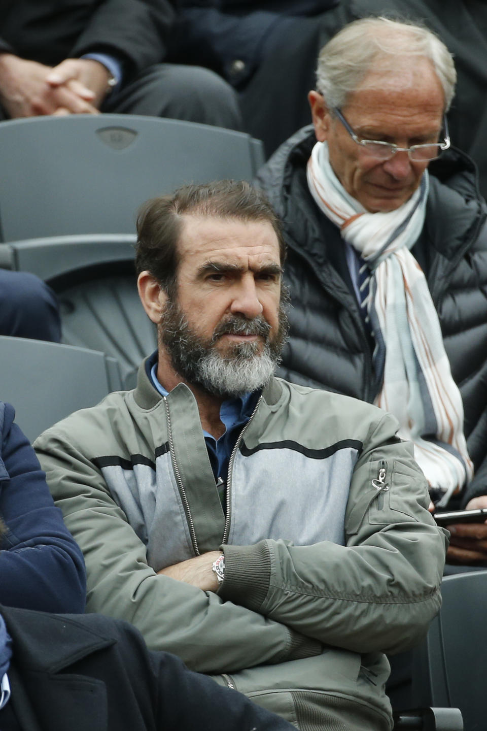 Former French soccer star Eric Cantona watches the semifinal match of the French Open tennis tournament between Britain's Andy Murray and Switzerland's Stan Wawrinka at the Roland Garros stadium in Paris, France, Friday, June 3, 2016. (AP Photo/Alastair Grant)