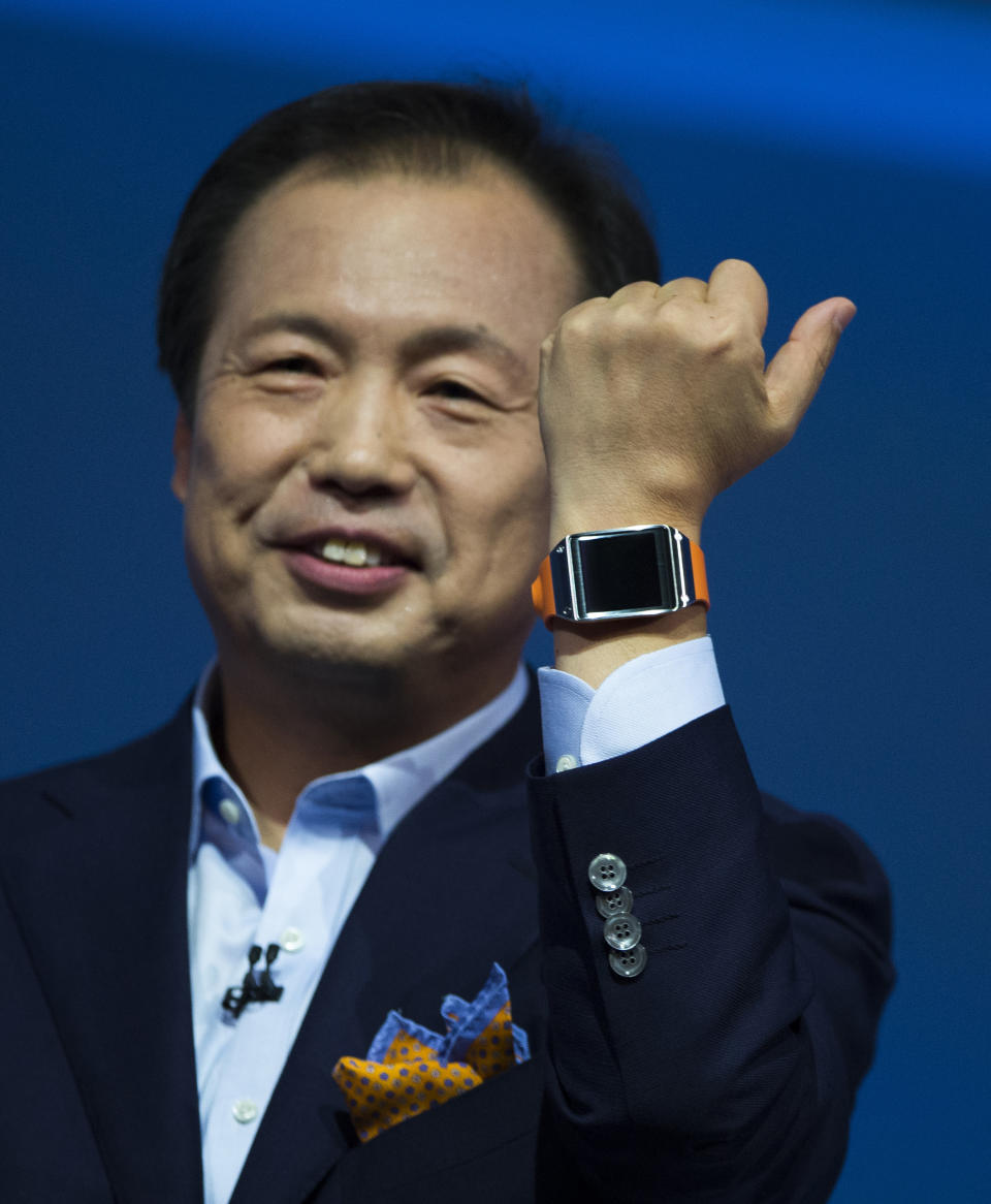 JK Shin, head of Samsung Mobile Communications, presents the Samsung Galaxy Gear in Berlin, Germany, Wednesday, Sept. 4, 2013. Samsung has unveiled a highly anticipated digital wristwatch well ahead of a similar product expected from rival Apple. The so-called smartwatch is what some technology analysts believe could become this year's must-have holiday gift. Samsung unveiled the Galaxy Gear on Wednesday in Berlin ahead of the annual IFA consumer electronics show. (AP Photo/Gero Breloer)