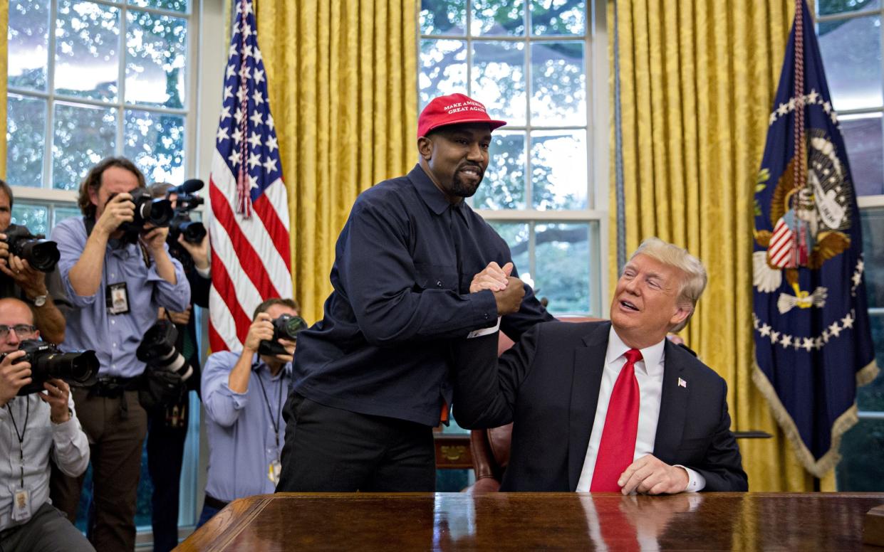 Kanye West shakes hands with US President Donald Trump in 2018 - Bloomberg