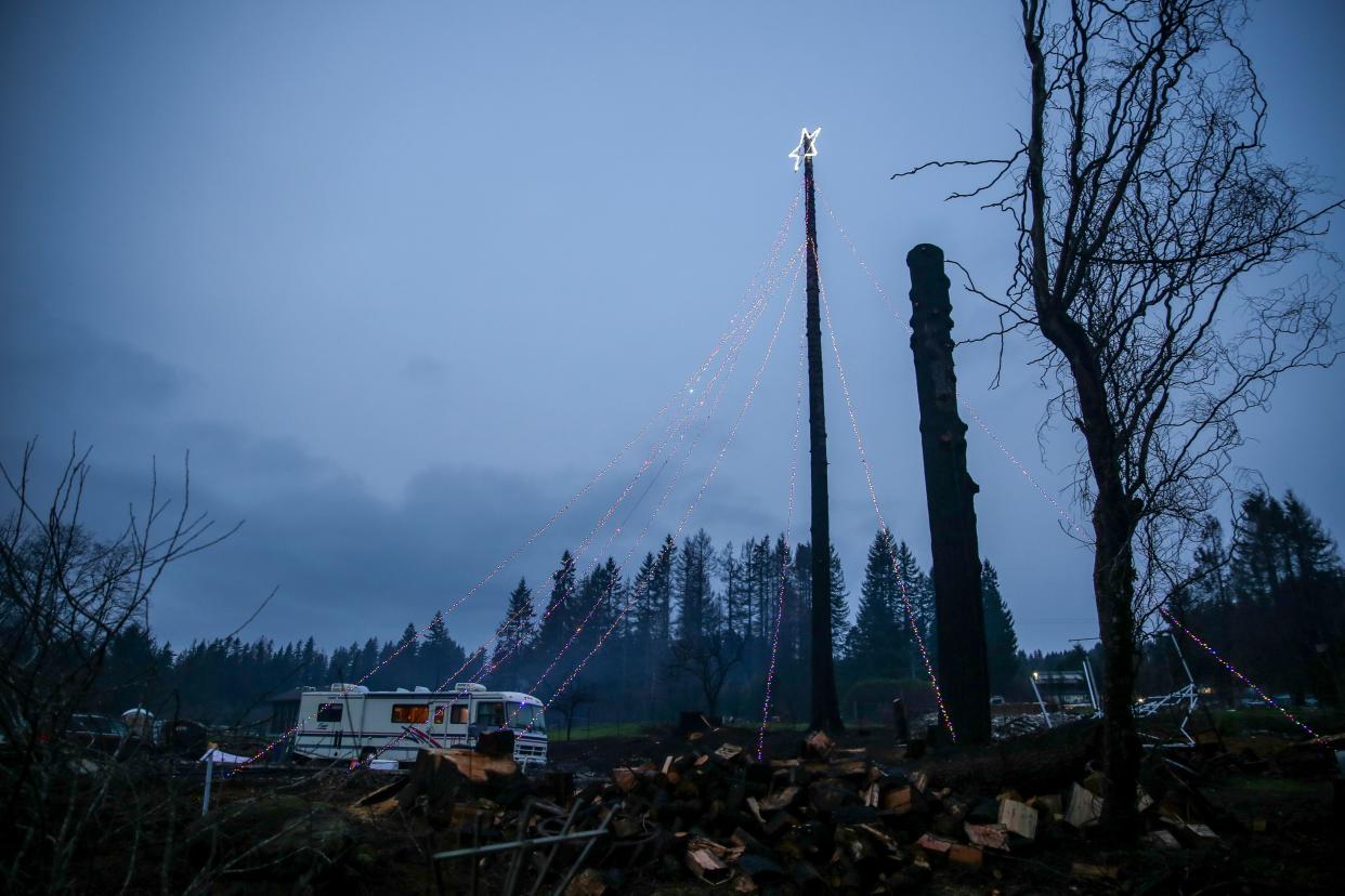 A Christmas star lights up Don Stuart's property that was destroyed during the 2020 Echo Mountain Fire on North Pony Trail Lane in Otis.