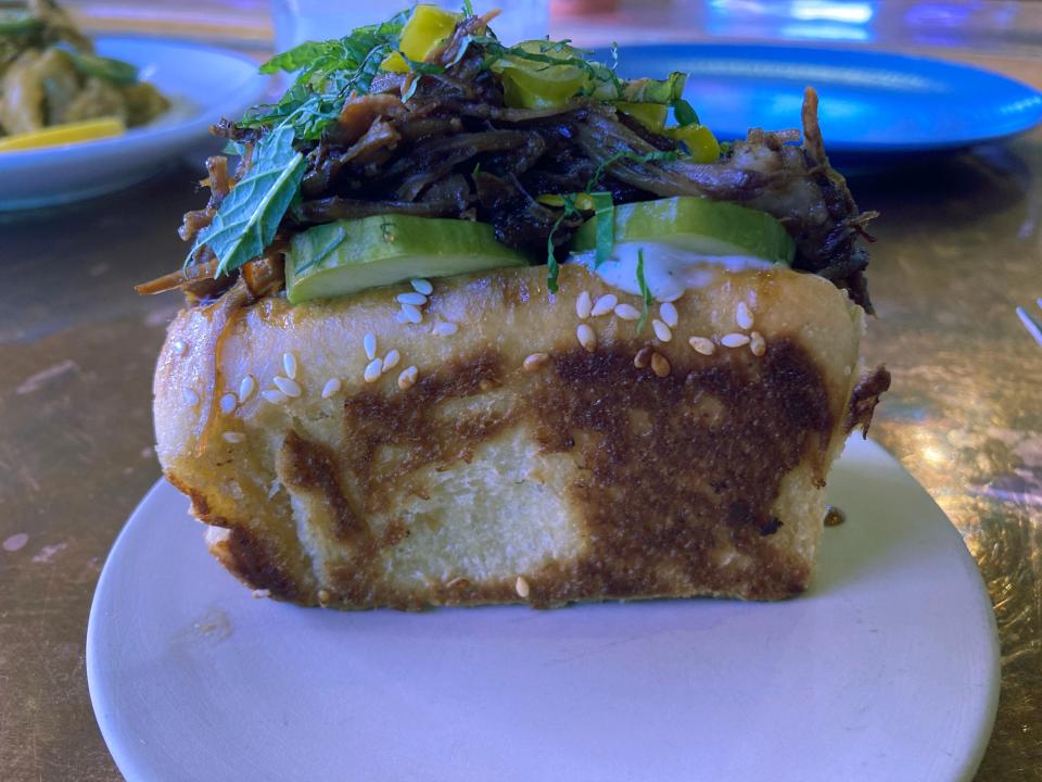 Braised lamb on a simit bun with pickles and herb mayo at Honey Road in Burlington on May 29, 2024.