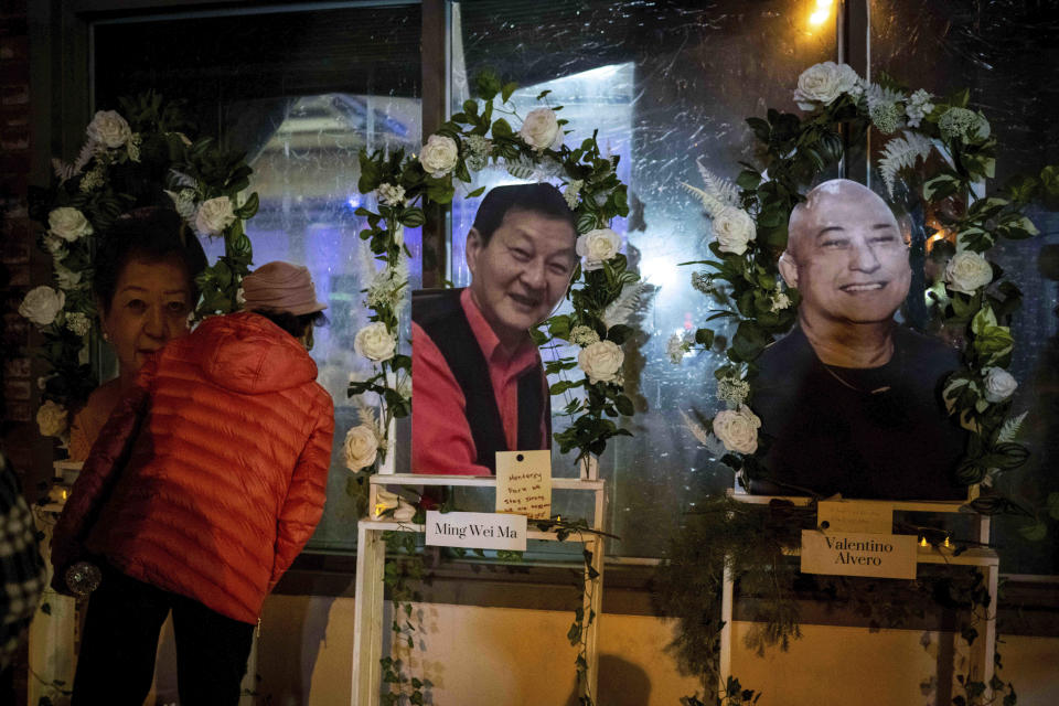 Dancer Lian Tang looks into The Star Ballroom Dance Studio on Tuesday, Jan. 24, 2023 where makeshift memorials have been set up for those killed in a mass shooting in the Monterey Park dance studio. (Sarah Reingewirtz/The Orange County Register via AP)